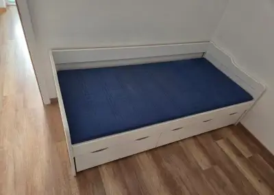 Drevená posteľ s matracom s 2 výsuvnými suflíkmi